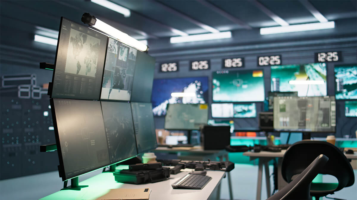 Panning shot of armed forces control room with radar systems tracking enemy
