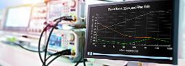 Computer monitor in front of oscilloscope, radio measuring equipment