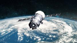 Spacecraft orbiting Earth in space.
