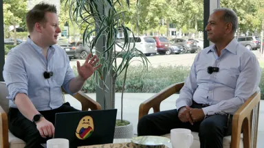 SiTime CEO Rajesh Vashist in an interview with TechTechPotato host, both seated and chatting during the discussion.